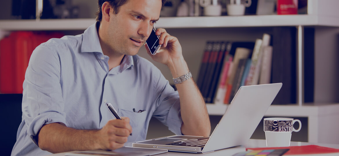 man on the phone working and taking notes